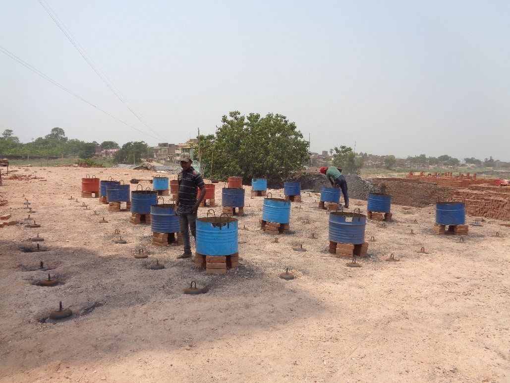 Firepersons set up the firing process on the top of the kiln. Photo by GKSPL