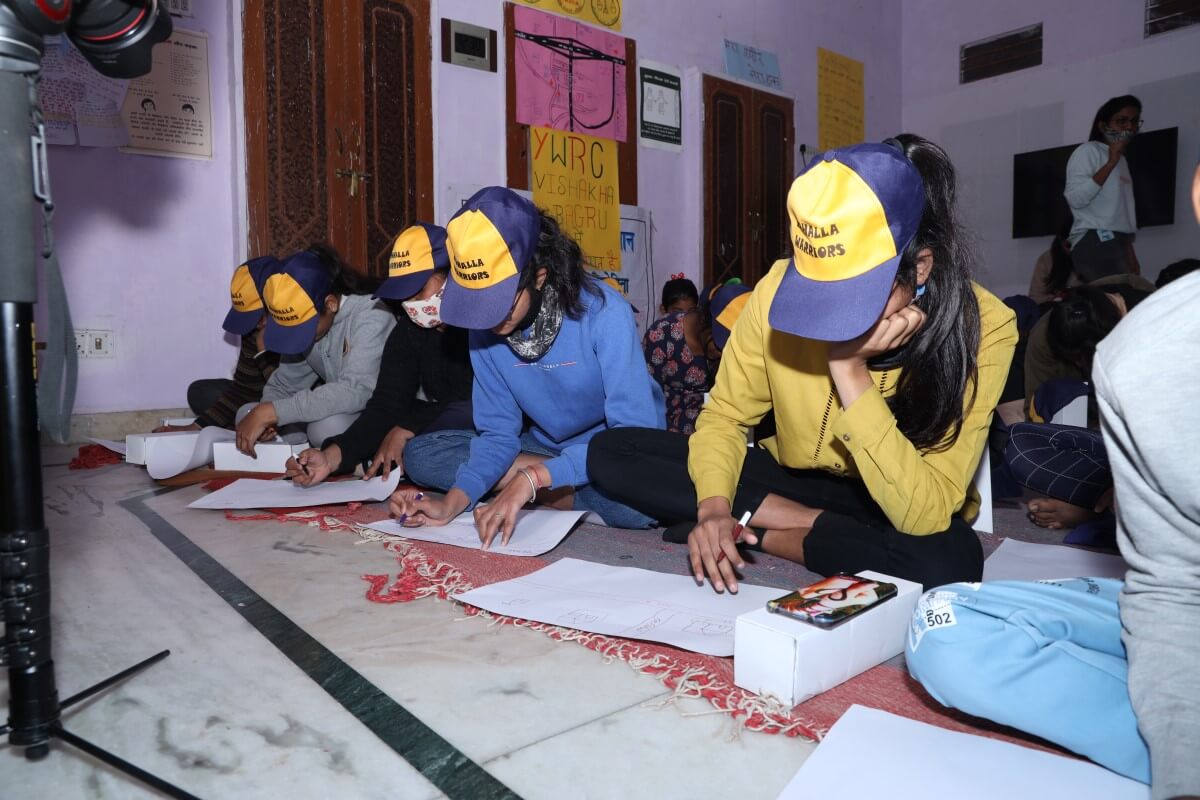 Adolescent participants engaged in a competitive activity for creating neighborhood maps as part of the workshop.