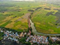 green farms and urban buildings drone shot