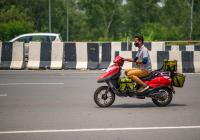 Delivery worker on a bike in the heat in Delhi