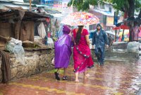 Woman and child in the rain on a walkway