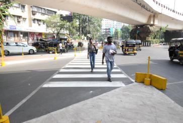 2 men on a street crossing/zebra crossing