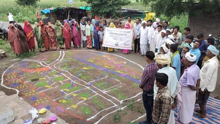 Residents of Matli assemble for a resource mapping exercise using rangoli patterns. 