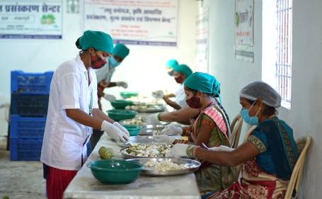 Women processing custard apple