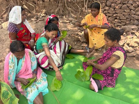 Women of forest-fringe villages pin Sal leaves with twigs. 