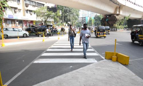 2 men on a street crossing/zebra crossing