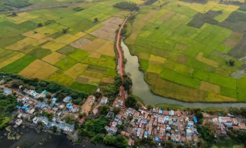 green farms and urban buildings drone shot