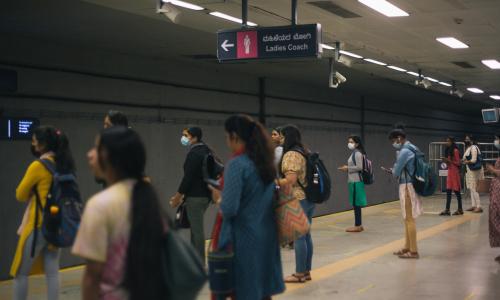 Women await the metro near the women's coach at a platform in Bengaluru