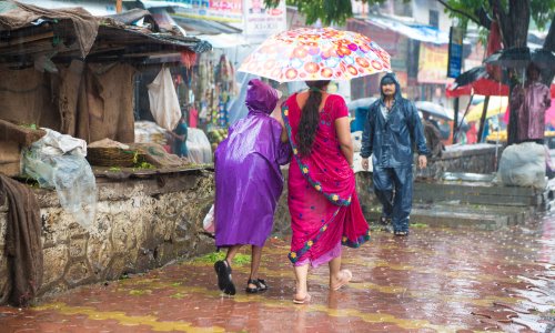 Woman and child in the rain on a walkway