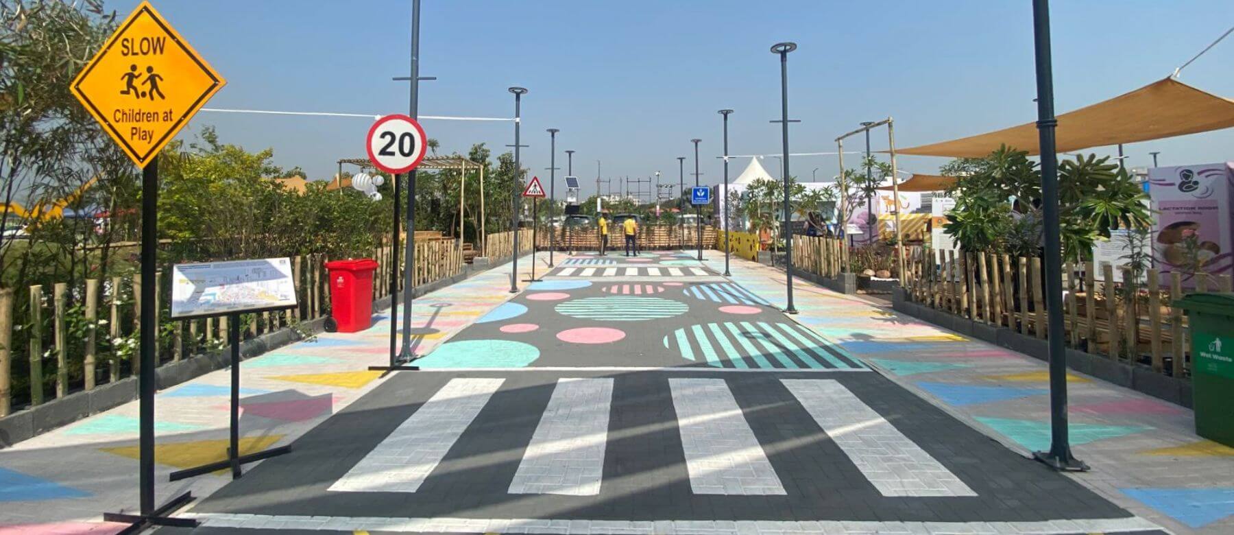 model street created at the Smart Cities Smart Urbanization 2022 conference incorporating all safety measures such as signages, streetlights, traffic calming measures such as painted junctions, painted cycle and pedestrian tracks, and plantation buffers at the street edges